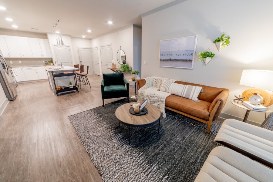 Spacious living room with plants in The Verge Luxury Apartments.