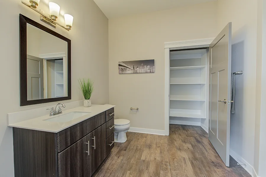 Prepare a power outage kit now and store it somewhere easily accessible like this spacious closet at Penrose on Mass Apartments. A spacious bathroom and closet at Penrose on Mass Apartments