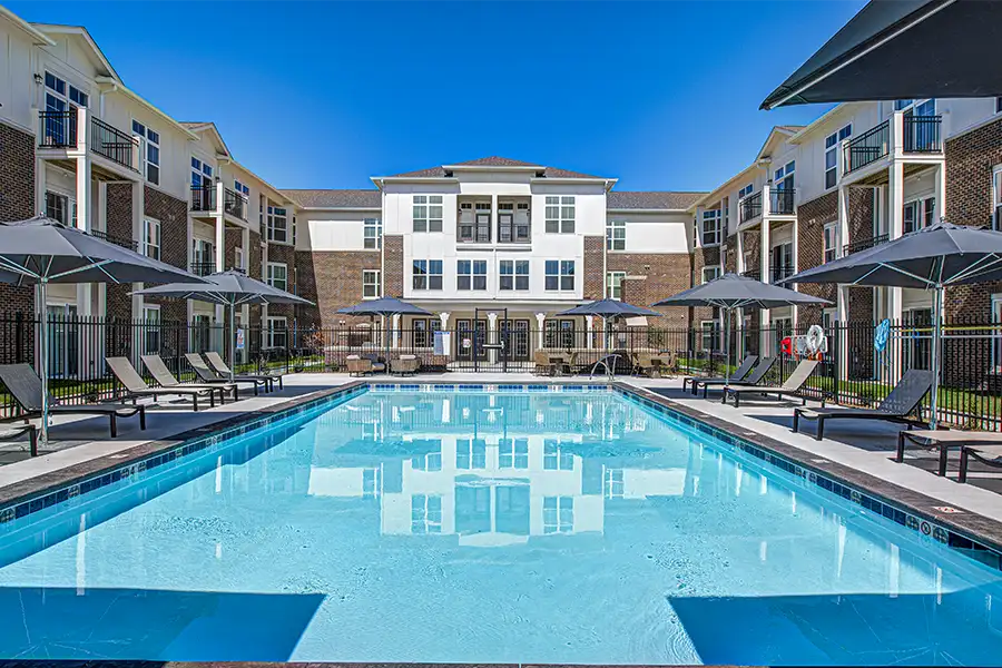 Pristine pool surrounded by apartment buildings at Lakeside Apartments.